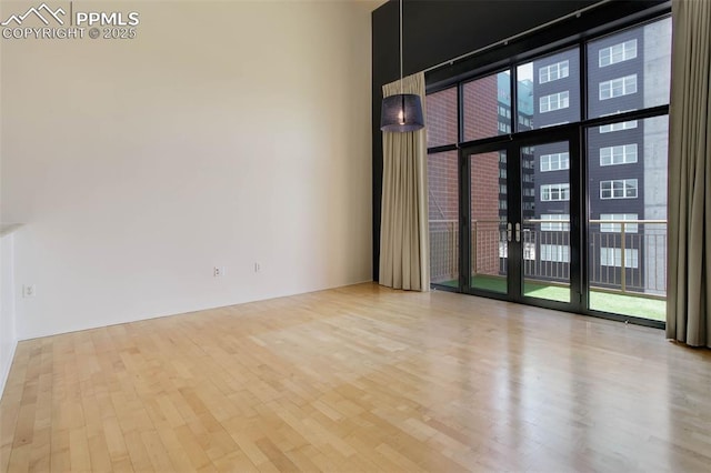 3100 Huron St Unit 4N, Denver, CO 80202 - spare room with expansive windows, wood finished floors, and a high ceiling