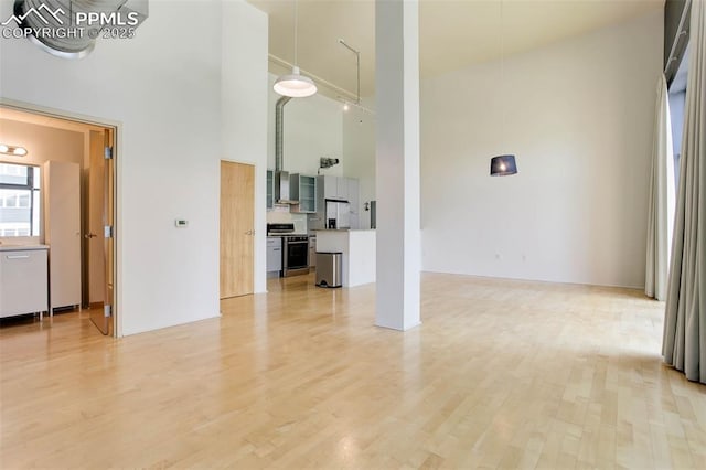 3100 Huron St Unit 4N, Denver, CO 80202 - unfurnished living room with a high ceiling and light wood-type flooring