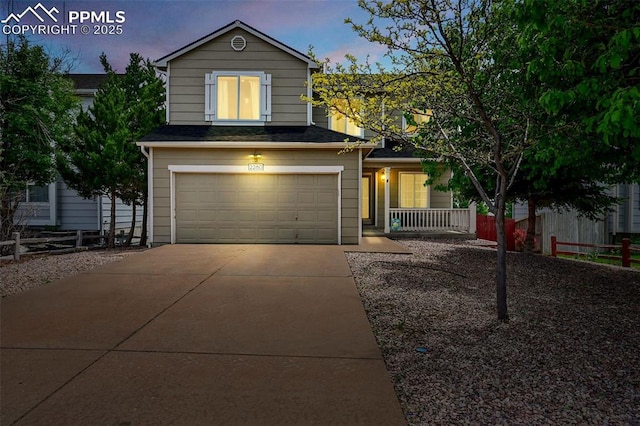 2280 Lisa Dr, Colorado Springs, CO 80915 - traditional-style home with an attached garage, concrete driveway, and a porch