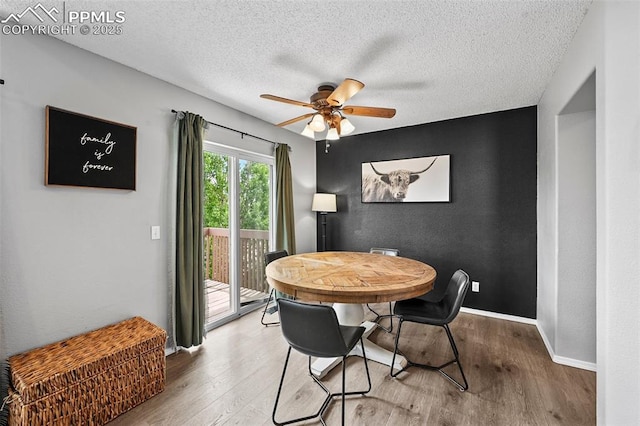 2280 Lisa Dr, Colorado Springs, CO 80915 - dining room featuring wood finished floors, a ceiling fan, baseboards, and a textured ceiling