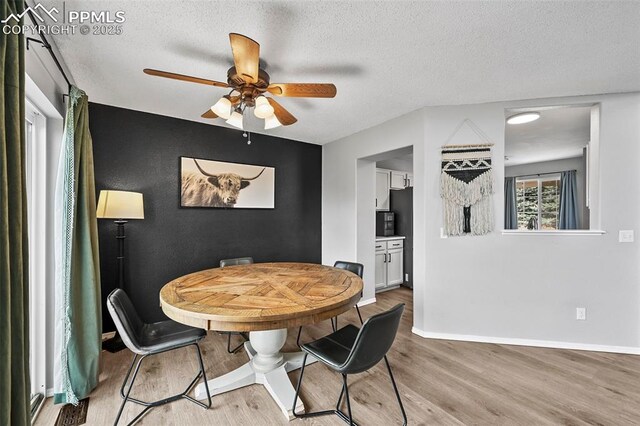2280 Lisa Dr, Colorado Springs, CO 80915 - dining area with a ceiling fan, light wood-style floors, a textured ceiling, and baseboards