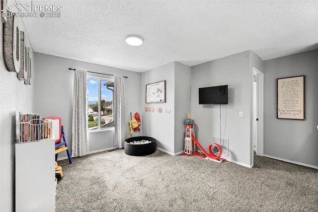 2280 Lisa Dr, Colorado Springs, CO 80915 - recreation room featuring carpet flooring, a textured ceiling, and baseboards