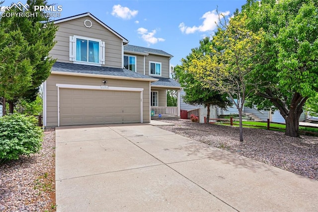 2280 Lisa Dr, Colorado Springs, CO 80915 - traditional-style house featuring an attached garage, driveway, and a shingled roof