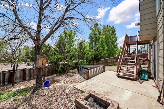 2280 Lisa Dr, Colorado Springs, CO 80915 - fenced backyard featuring stairs, a patio area, and a vegetable garden