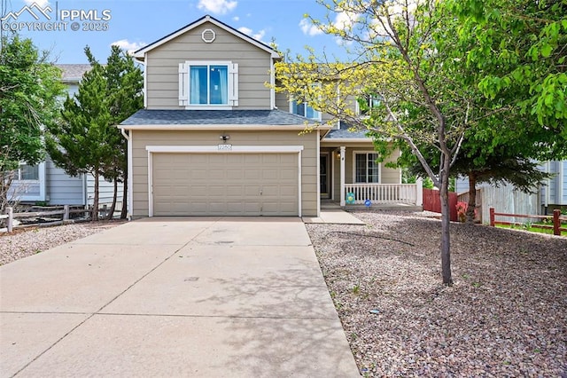 2280 Lisa Dr, Colorado Springs, CO 80915 - traditional-style house with an attached garage, a porch, concrete driveway, and roof with shingles