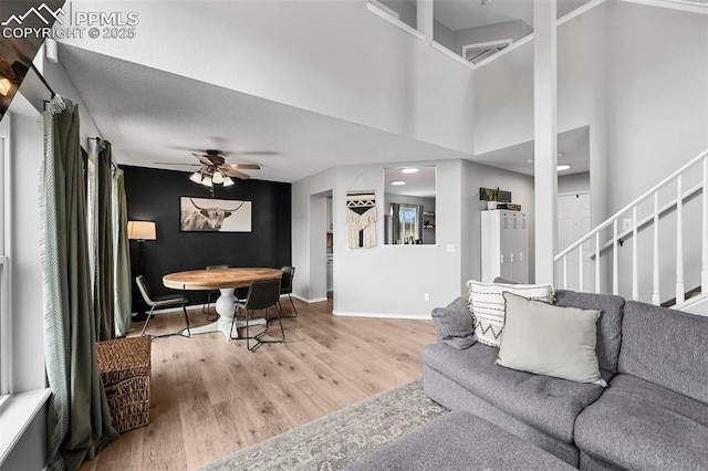 2280 Lisa Dr, Colorado Springs, CO 80915 - living room featuring wood finished floors, ceiling fan, baseboards, and stairs