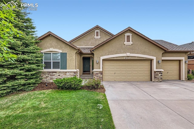 2513 Cinnabar Rd, Colorado Springs, CO 80921 - view of front facade with stone siding, stucco siding, driveway, a garage, and a front lawn