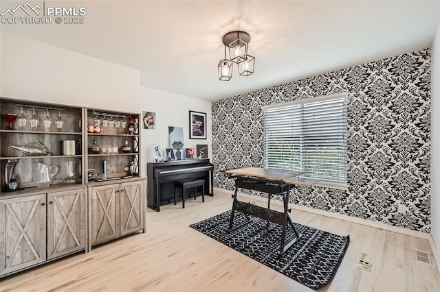 2513 Cinnabar Rd, Colorado Springs, CO 80921 - dining area with wallpapered walls, light wood finished floors, and baseboards