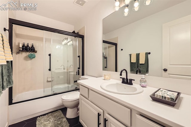 2513 Cinnabar Rd, Colorado Springs, CO 80921 - full bath with toilet, vanity, tile patterned flooring, and bath / shower combo with glass door