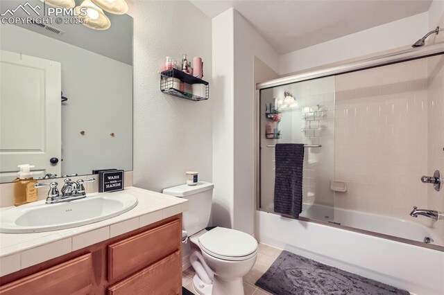 2513 Cinnabar Rd, Colorado Springs, CO 80921 - bathroom with toilet, vanity, combined bath / shower with glass door, and tile patterned floors
