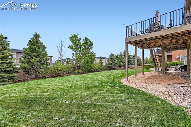 2513 Cinnabar Rd, Colorado Springs, CO 80921 - view of green lawn featuring stairs, a wooden deck, and a patio area