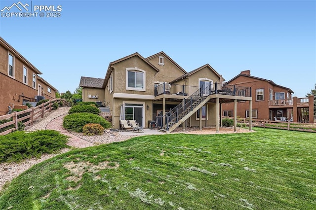 2513 Cinnabar Rd, Colorado Springs, CO 80921 - rear view of property featuring stairs, a deck, stucco siding, and a patio area