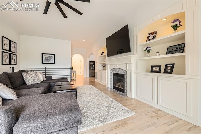 2513 Cinnabar Rd, Colorado Springs, CO 80921 - living area with a ceiling fan, arched walkways, built in features, lofted ceiling, and light wood-style floors