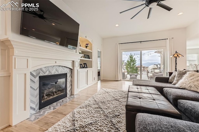 2513 Cinnabar Rd, Colorado Springs, CO 80921 - living area with ceiling fan, light wood-style flooring, a fireplace, built in shelves, and recessed lighting