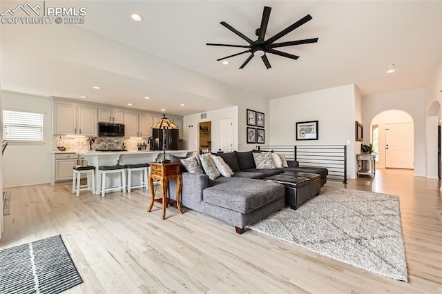 2513 Cinnabar Rd, Colorado Springs, CO 80921 - living room featuring ceiling fan, arched walkways, light wood finished floors, recessed lighting, and baseboards