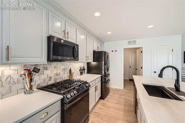 2513 Cinnabar Rd, Colorado Springs, CO 80921 - kitchen featuring black appliances, a sink, light countertops, backsplash, and recessed lighting