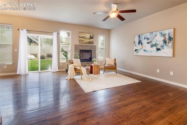 4228 Notch Trl, Colorado Springs, CO 80924 - living area with a ceiling fan, a fireplace, baseboards, and dark wood finished floors