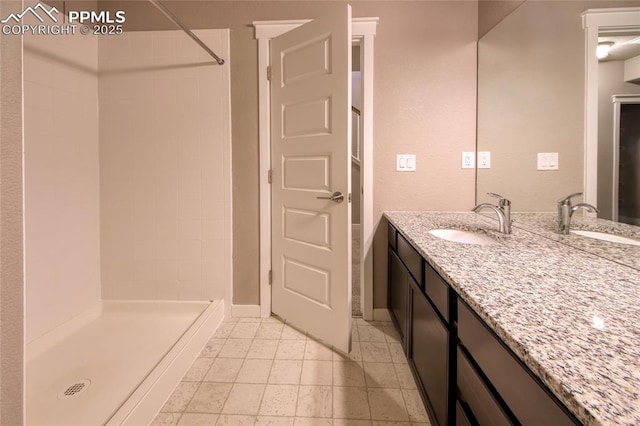 4228 Notch Trl, Colorado Springs, CO 80924 - full bathroom with a tile shower, vanity, and baseboards