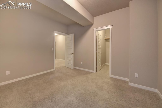 4228 Notch Trl, Colorado Springs, CO 80924 - unfurnished bedroom with carpet floors, a walk in closet, and baseboards