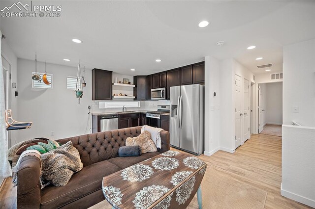 5840 Thurless Ln, Colorado Springs, CO 80927 - living area with light wood finished floors, recessed lighting, and baseboards