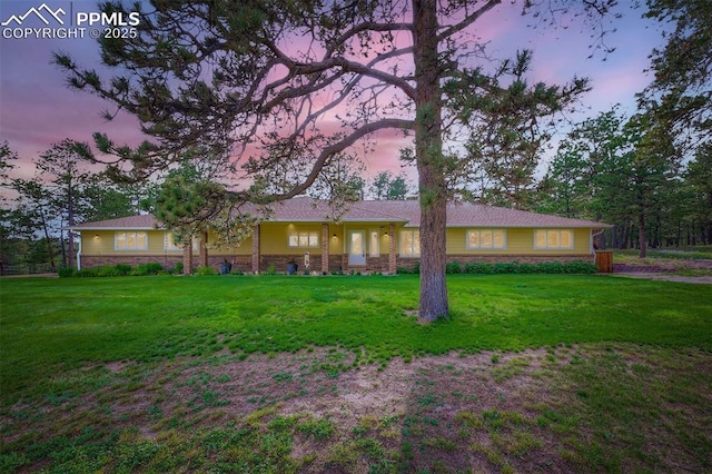 14820 Spiritwood Loop, Elbert, CO 80106 - ranch-style house featuring a lawn and stone siding