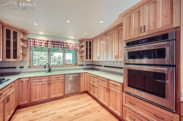 14820 Spiritwood Loop, Elbert, CO 80106 - kitchen with stainless steel appliances, open shelves, light brown cabinets, decorative backsplash, and recessed lighting
