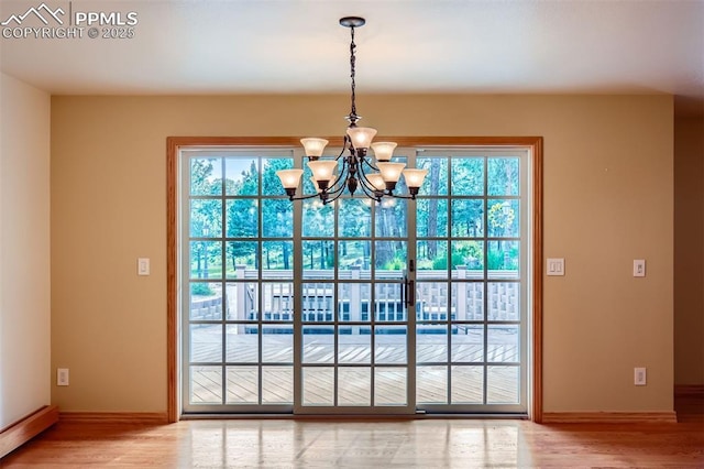 14820 Spiritwood Loop, Elbert, CO 80106 - entryway featuring a chandelier, plenty of natural light, and light wood-style floors