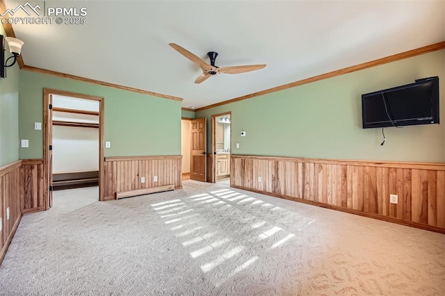 14820 Spiritwood Loop, Elbert, CO 80106 - unfurnished room with wainscoting, ceiling fan, crown molding, carpet, and baseboard heating