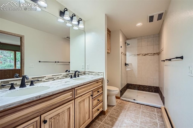 14820 Spiritwood Loop, Elbert, CO 80106 - bathroom with double vanity, a tile shower, tile patterned flooring, and recessed lighting