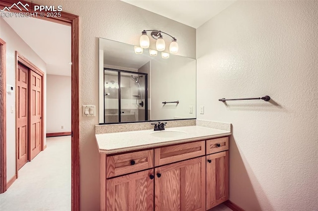 14820 Spiritwood Loop, Elbert, CO 80106 - bathroom with a textured wall, vanity, and a stall shower