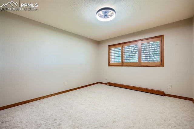 14820 Spiritwood Loop, Elbert, CO 80106 - carpeted spare room featuring baseboards and a baseboard radiator