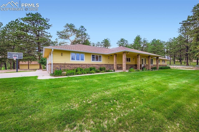 14820 Spiritwood Loop, Elbert, CO 80106 - single story home with brick siding, a front lawn, and driveway