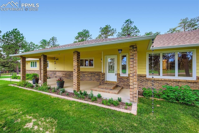 14820 Spiritwood Loop, Elbert, CO 80106 - view of front of house with brick siding, a front yard, and roof with shingles