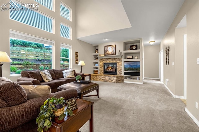 12265 Jones Park Ct, Colorado Springs, CO 80921 - living room featuring built in shelves, a fireplace, carpet floors, baseboards, and a towering ceiling