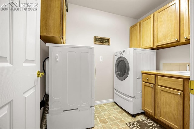 12265 Jones Park Ct, Colorado Springs, CO 80921 - laundry area with cabinet space, washer / dryer, and baseboards