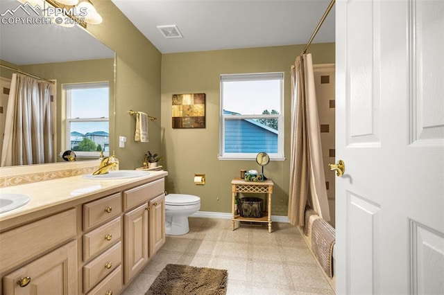 12265 Jones Park Ct, Colorado Springs, CO 80921 - bathroom featuring toilet, double vanity, tile patterned floors, baseboards, and shower / bath combo with shower curtain