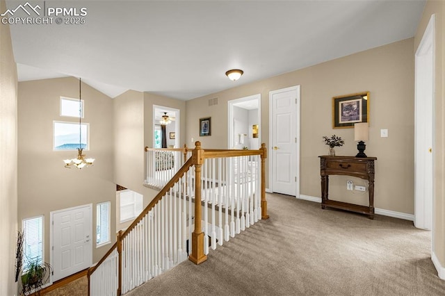 12265 Jones Park Ct, Colorado Springs, CO 80921 - hallway featuring an upstairs landing, a chandelier, carpet floors, baseboards, and vaulted ceiling