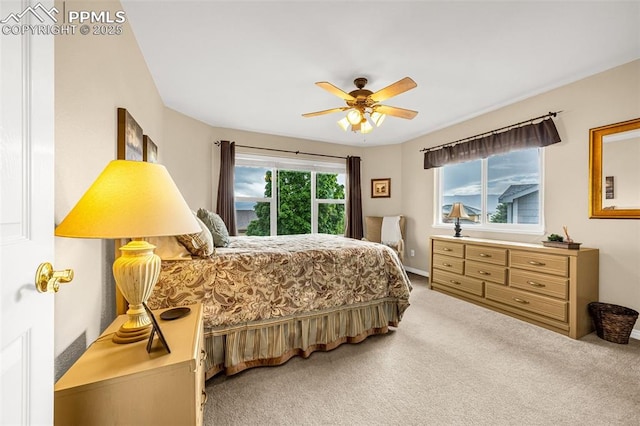 12265 Jones Park Ct, Colorado Springs, CO 80921 - bedroom with light colored carpet, a ceiling fan, and baseboards