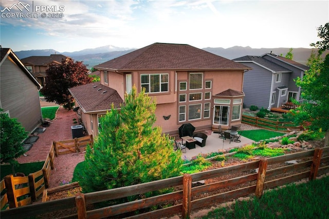 12265 Jones Park Ct, Colorado Springs, CO 80921 - rear view of property with stucco siding, a mountain view, a patio area, a fenced backyard, and central air condition unit