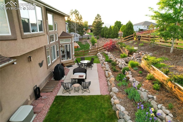 12265 Jones Park Ct, Colorado Springs, CO 80921 - fenced backyard with a patio and outdoor dining space