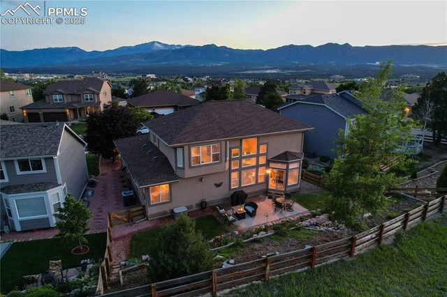 12265 Jones Park Ct, Colorado Springs, CO 80921 - rear view of property featuring a fenced backyard, a patio, a mountain view, stucco siding, and a residential view