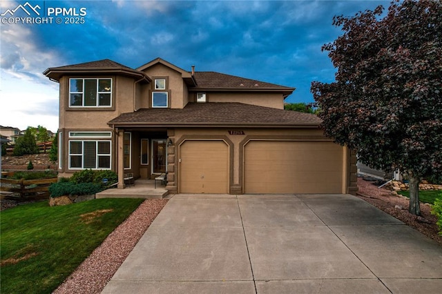 12265 Jones Park Ct, Colorado Springs, CO 80921 - view of front of house featuring an attached garage, stucco siding, driveway, and a front lawn