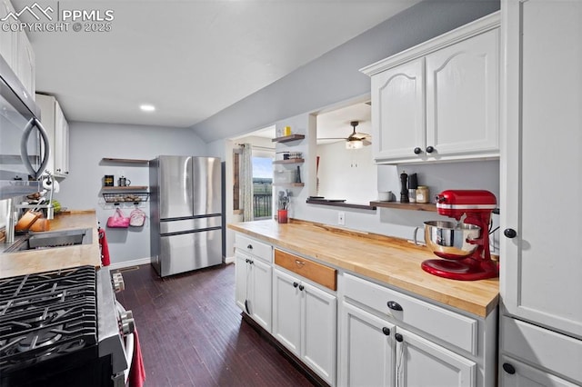 18420 1st St, Peyton, CO 80831 - kitchen featuring appliances with stainless steel finishes, wood counters, open shelves, and white cabinetry