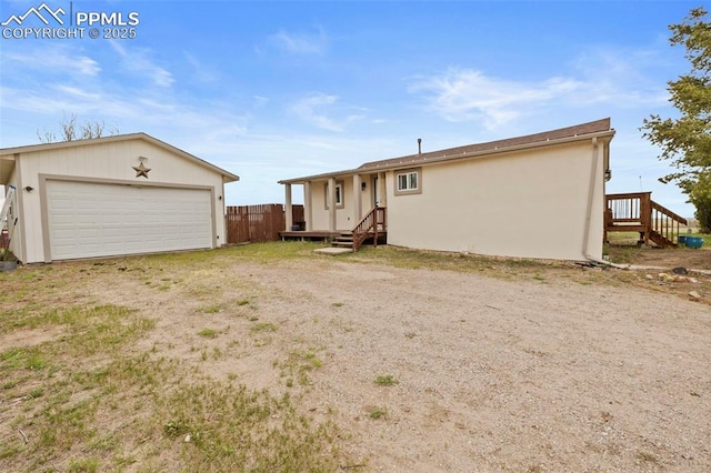 18420 1st St, Peyton, CO 80831 - rear view of house featuring a detached garage and stucco siding