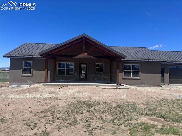 55 Kryptonite Ct, Westcliffe, CO 81252 - back of property with a standing seam roof, metal roof, stucco siding, a garage, and covered porch