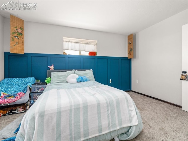 1159 N Linda Ln, Pueblo West, CO 81007 - carpeted bedroom featuring a wainscoted wall and a decorative wall