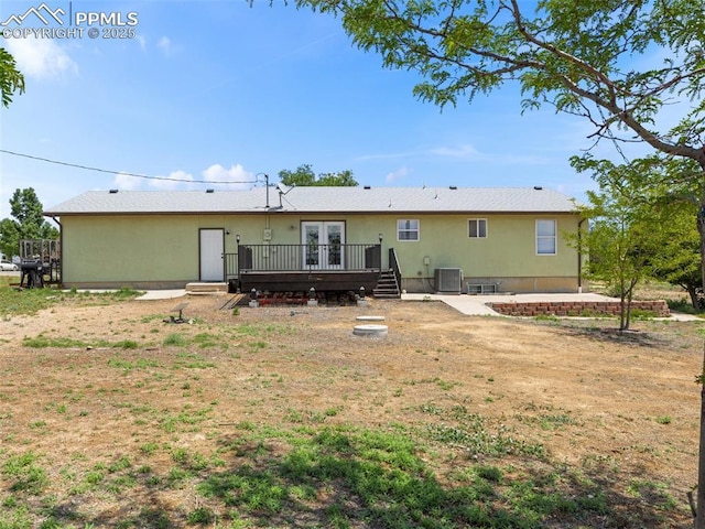 1159 N Linda Ln, Pueblo West, CO 81007 - back of house featuring french doors, a deck, central AC unit, and stucco siding