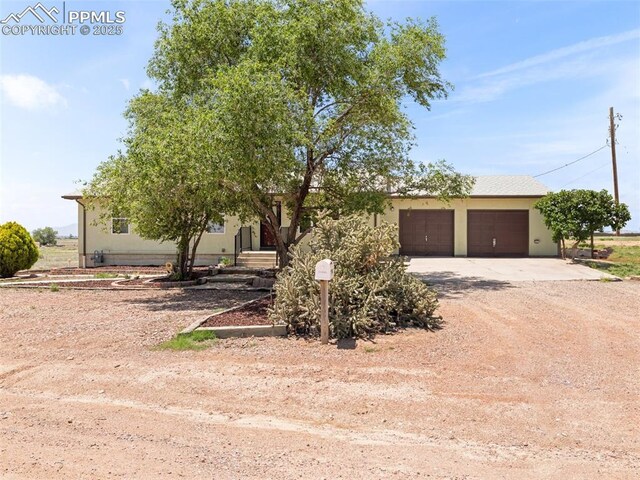 1159 N Linda Ln, Pueblo West, CO 81007 - view of front of property with driveway, stucco siding, and a garage