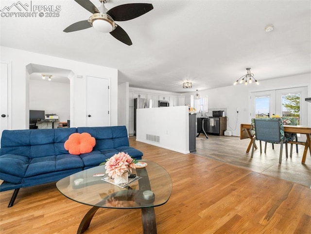 1159 N Linda Ln, Pueblo West, CO 81007 - living area with a ceiling fan, a chandelier, and light wood-style floors