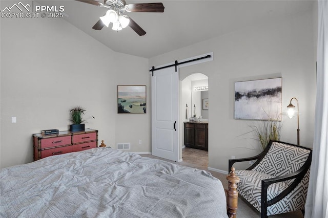 8795 Canary Cir, Colorado Springs, CO 80908 - bedroom with light carpet, a barn door, arched walkways, baseboards, and vaulted ceiling